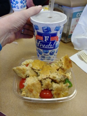 A salmon cake added to a deli pasta salad.