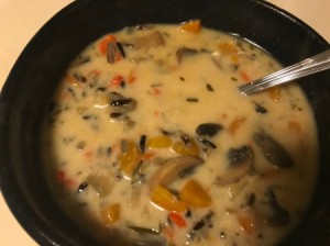 A bowl of mushroom and wild rice soup cooked in an Instant Pot pressure cooker.