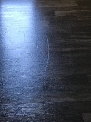 A white mark on a vinyl floor.