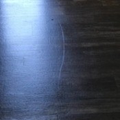 A white mark on a vinyl floor.