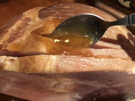 spreading marinade on slicedHam