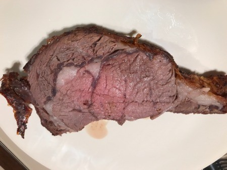 cut Bone-in Prime Rib Roast on plate