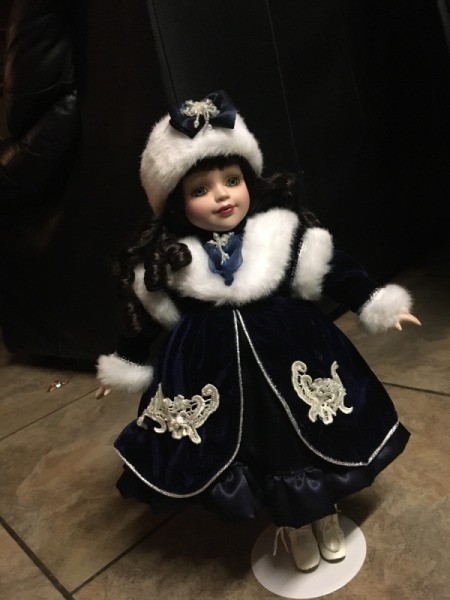 Identifying a Porcelain Doll - dark haired doll wearing a fur trimmed coat and fur hat