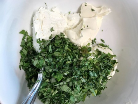 chopped basil and cheeses in bowl