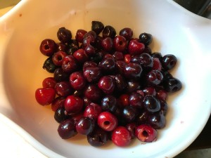 A bowl containing pitted cherries.