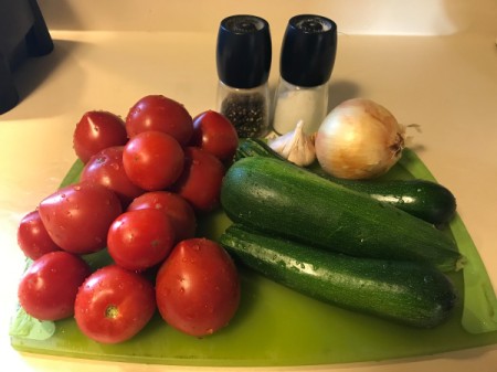 A cutting board filled with the ingredients for Roasted Tomato Soup.