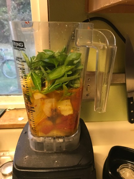 A blender filled with the ingredients for tomato soup.