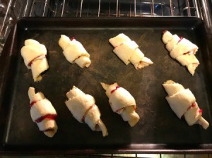 Rolled crescent rolls with jam and brie in the middle.