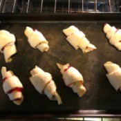 Rolled crescent rolls with jam and brie in the middle.