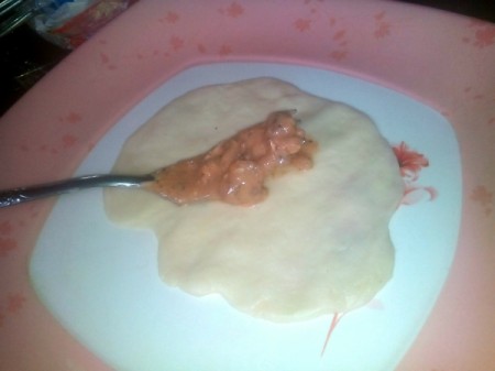 adding filling to flattened dough