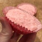 A pink bath bomb in a cupcake liner.