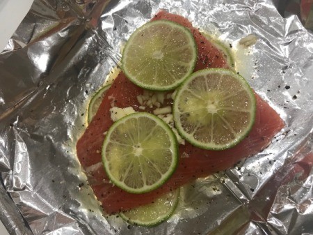 salmon with marinade and lime slices