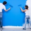 Couple Painting a Blue Wall