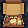 A Christmas box with a selection of summer sausage, cheese and jams.