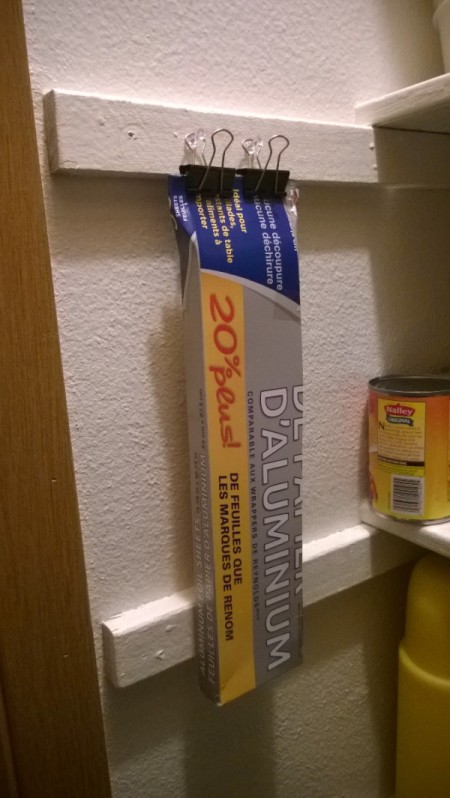 Binder clips being used to store a homemade cardboard knife case.