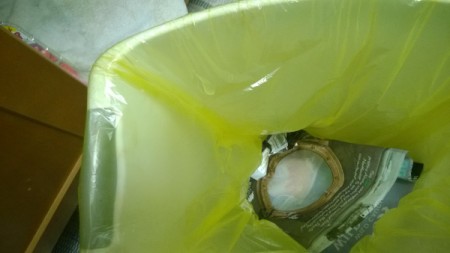A hole poked at the top of the trash bag to avoid an air pocket.