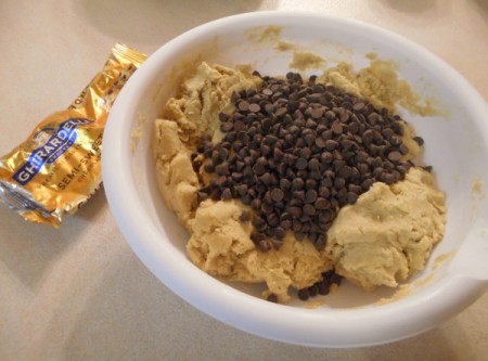 adding chocolate chips to dough