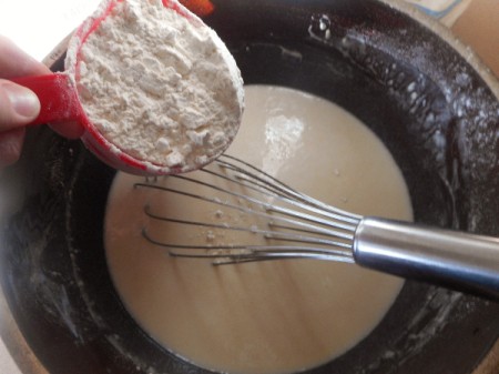 adding flour to yeast