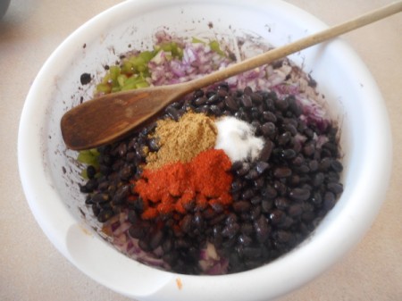 adding veggies to smashed beans