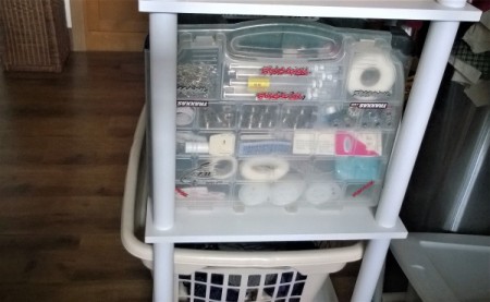 An old RC car box that has been repurposed for craft supply storage.