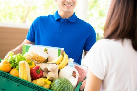 Man Delivering Food to a Woman at Home