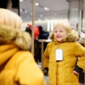 Kid Trying on Coat at Store