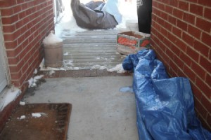 A tarp on the ground outside to protect the concrete from ice and snow.