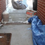 A tarp on the ground outside to protect the concrete from ice and snow.