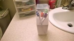 A collection of toothbrushes in a plastic container.