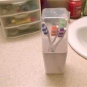 A collection of toothbrushes in a plastic container.