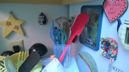 Kitchen tools stored in a clear plastic container.
