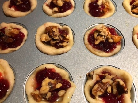 added walnuts to muffin tins