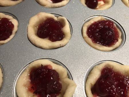 added cranberry to muffin tins
