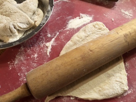 rolling pieces of bread dough