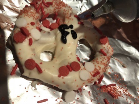 coated, sprinkled pretzel with name in black