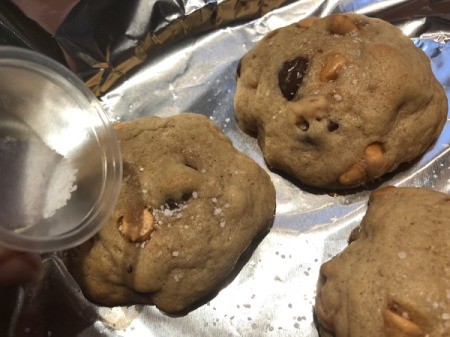 sprinkling baked cookies with salt
