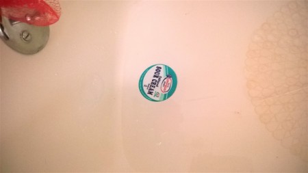A drain temporarily plugged with a sour cream lid.