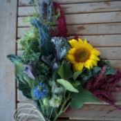 A bouquet of edible flowers on a wooden table.