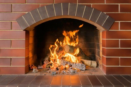 Brick Fireplace with Fire Burning