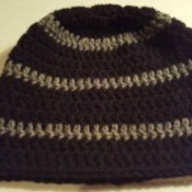 A crochete skull-cap in grey and black.