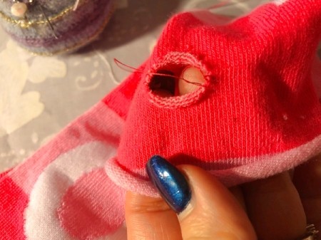 DIY Arm Warmers from Socks - turn inside out and make knot stitches around the thumb hole