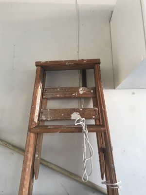 Safe Ladder Storage - ladder hanging on wall