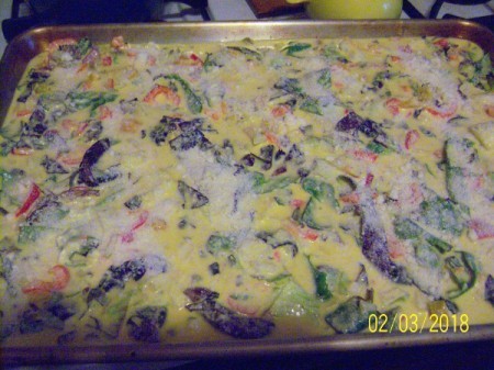 spreading egg mixture on baking sheet