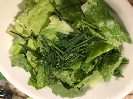washed lettuce and chives in bowl