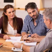 Couple Speaking With Real Estate Lawyer