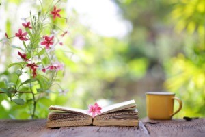 Book Flowers and Coffee Cup on Table