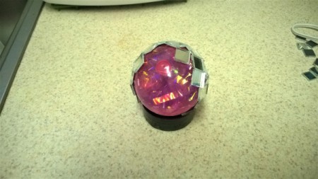 Mirror Ball for Cats  - partially finished ball sitting on a spice jar lid