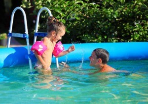 Kids Playing in Above Ground Swimming Pool