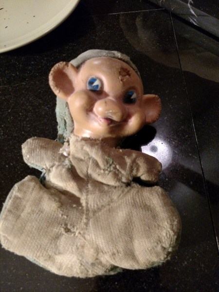 A vintage stuffed toy with a vinyl head.