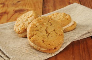 Peanut Butter Sandwich Cookies on a beige dish cloth.